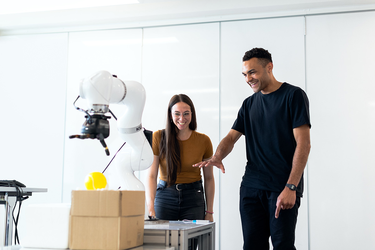 Image of two people testing out some artificial intellegense